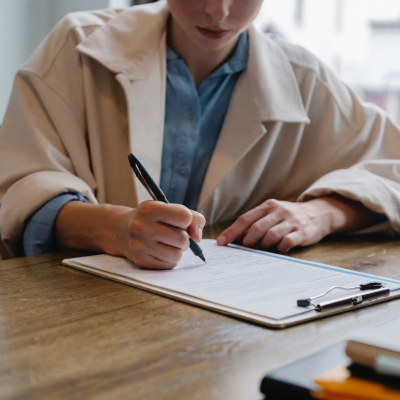 woman signing papers